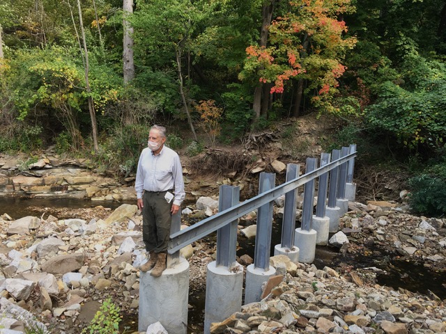 Dr. Roy Larick standing on the Trash Rack.